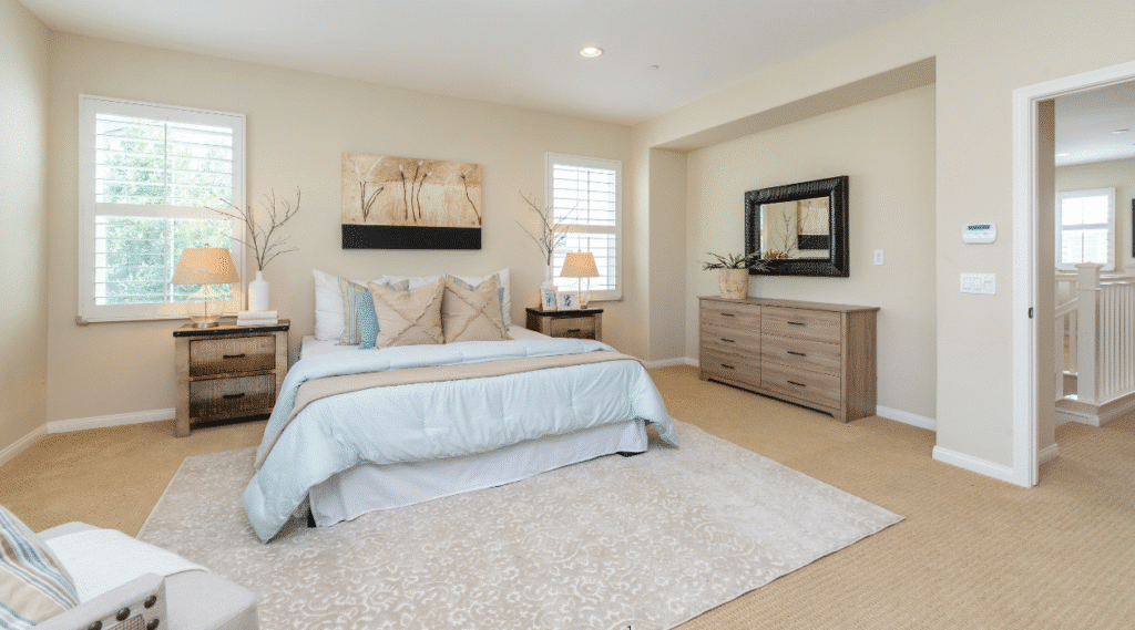 a bedroom with a bed and dressers